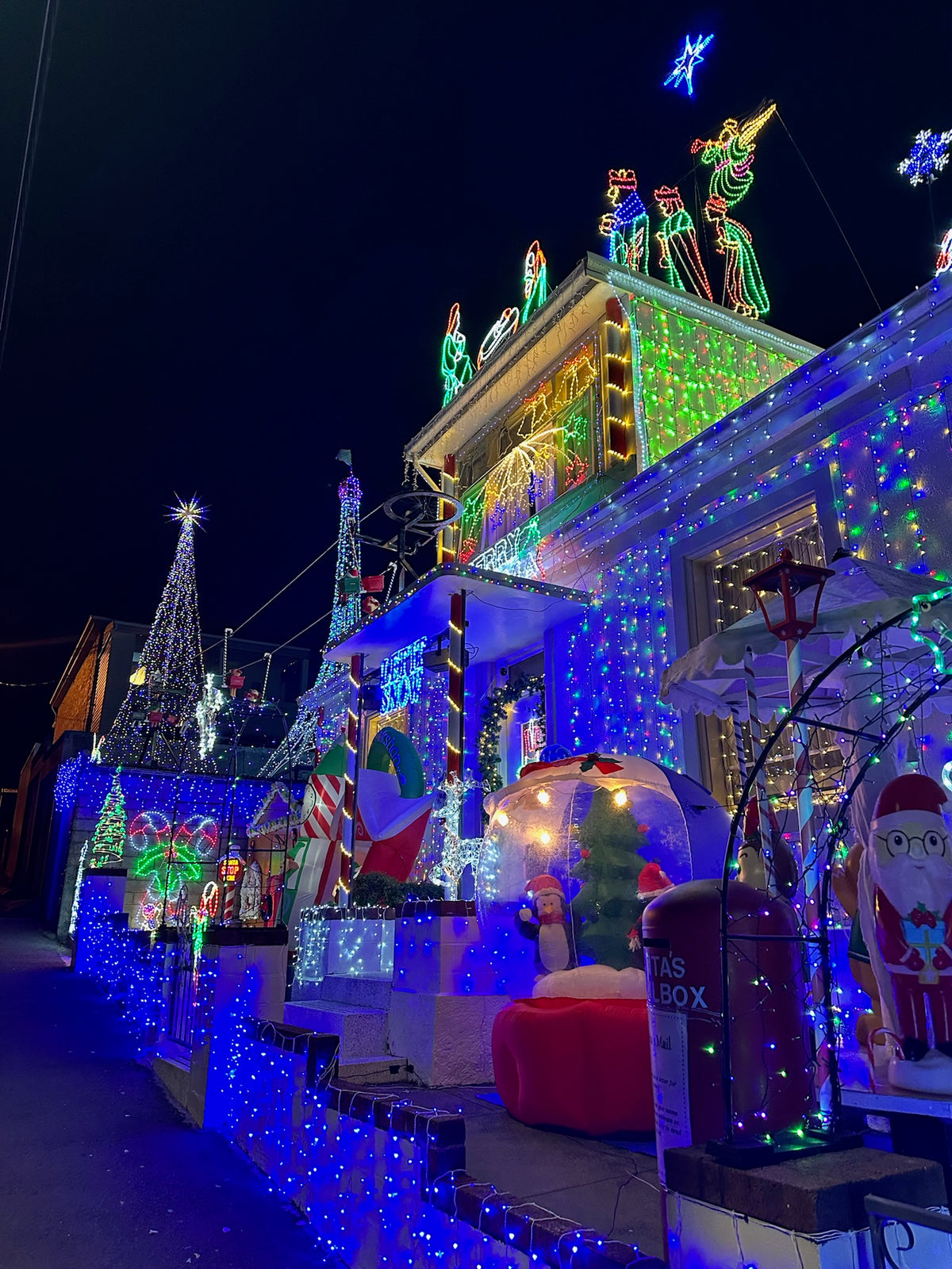Johnnys Christmas Light Display lit up at night 