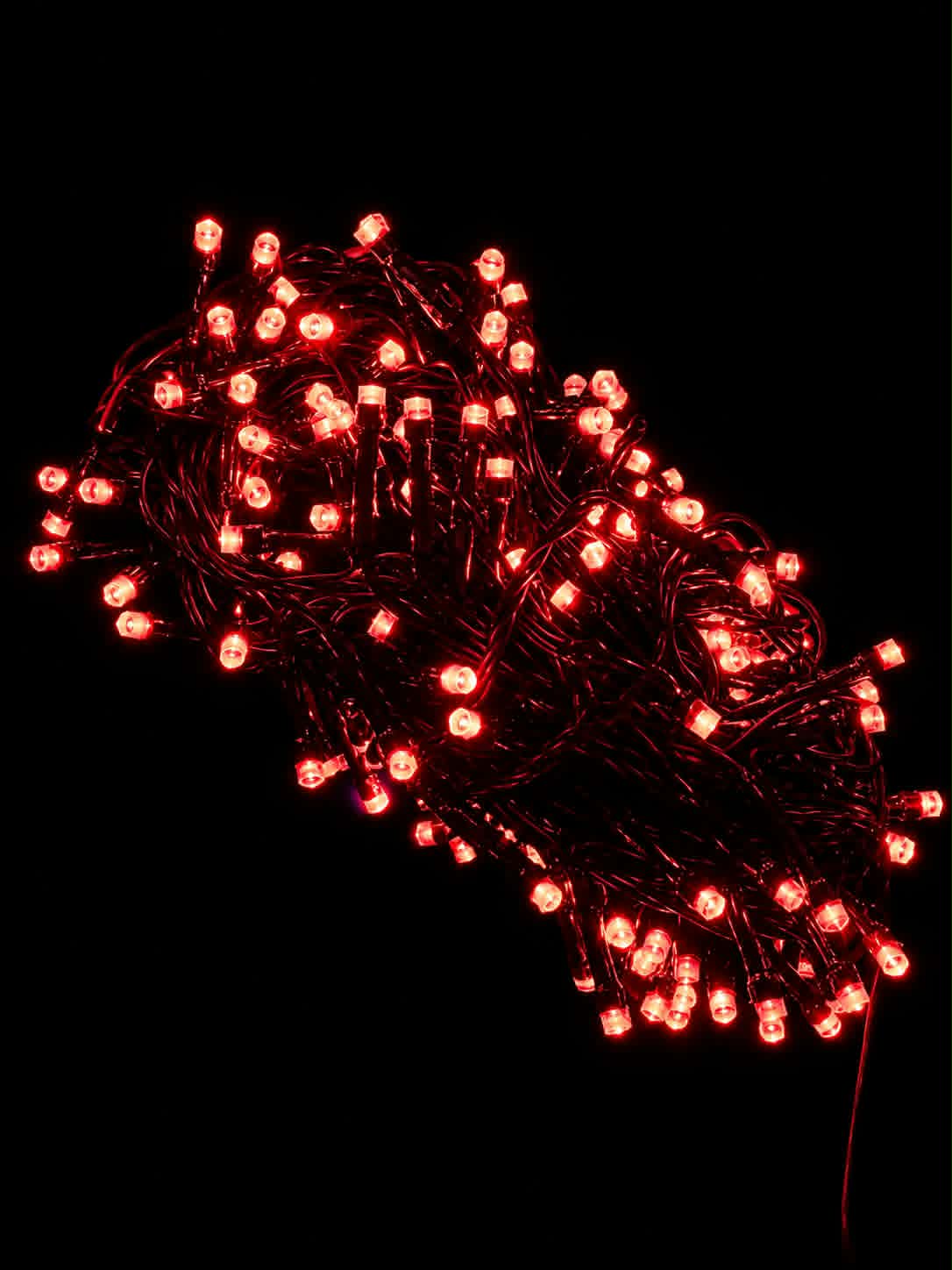 Neon Noel - red LED fairy lights glowing brightly against a solid black background.