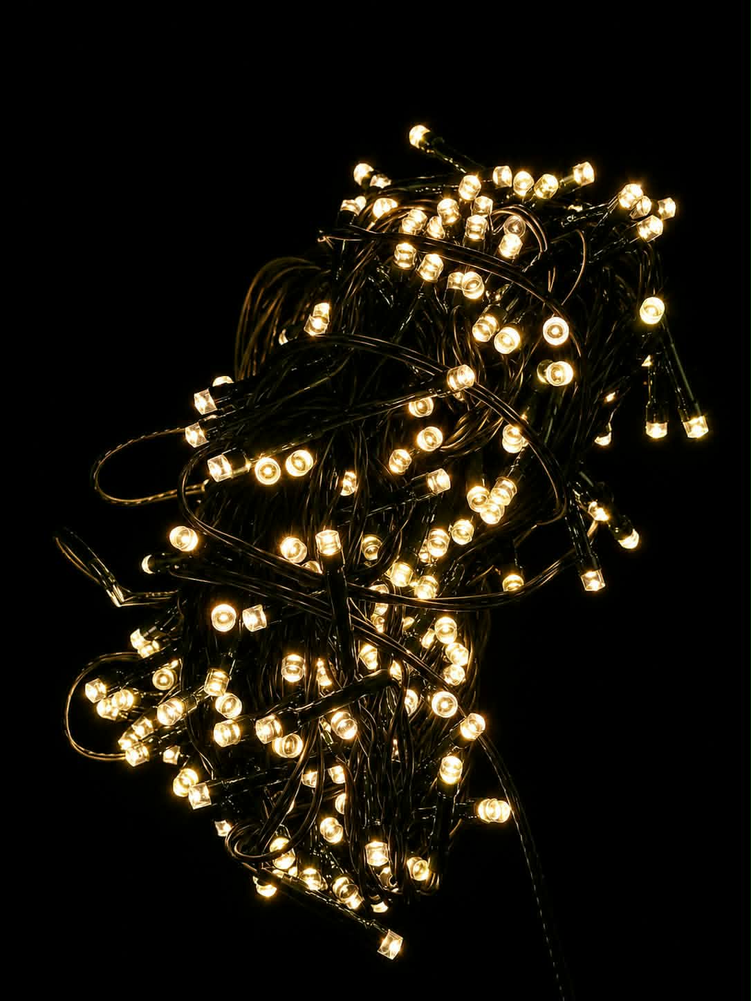 Neon Noel - warm white LED string lights on a black background.